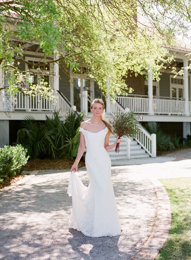 Modern Trousseau’s “Hepburn” guipure lace gown available from Modern Trousseau flagship stores in Charleston, Savannah, and Nashville. Gold and diamond earrings and ring from Roberto Coin. Christina Jervey cuffs from Gwynn’s of Mount Pleasant. Bouquet by Fox Events