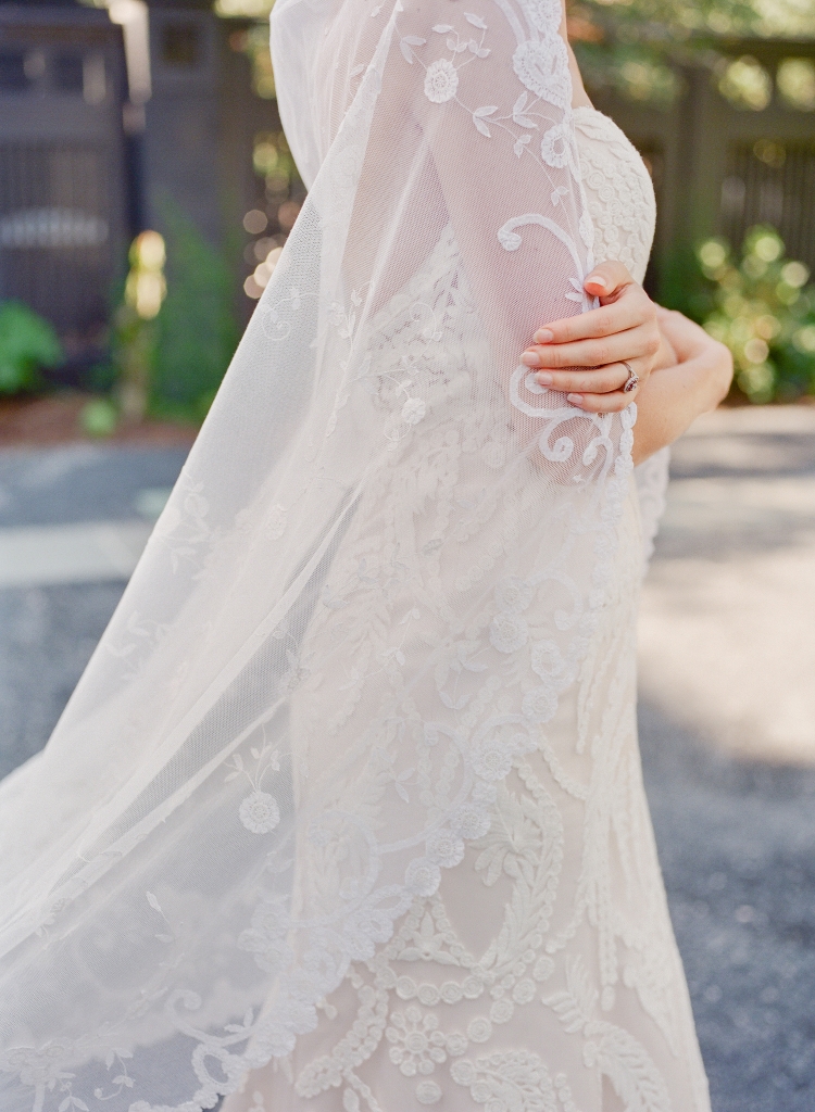 Casablanca Bridal’s “Zinnia” ivory cotton lace and champagne-colored satin fit-to-flare gown from Palmetto Bridal Boutique. Mariée Lace Veils’ “121” princess lace veil. Kwiat diamond and ruby ring from Paulo Geiss Jewelers. (Photo by Corbin Gurkin)