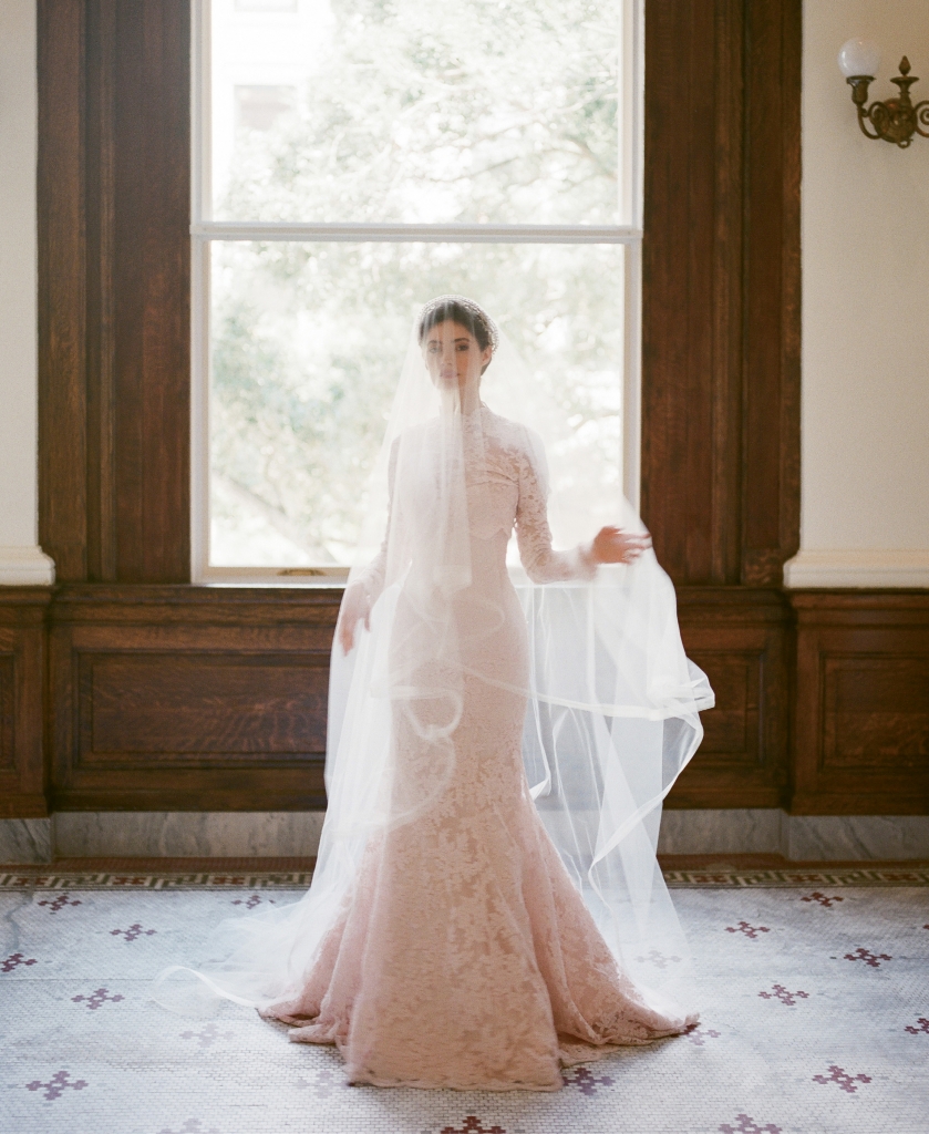 Legends Romona Keveza’s L7125 rose lace fit-to-flare gown with illusion blouse, both from Maddison Row. Photographer’s vintage crown. Untamed Petals’ “Cypress” veil from Lovely. (Photo by Corbin Gurkin)