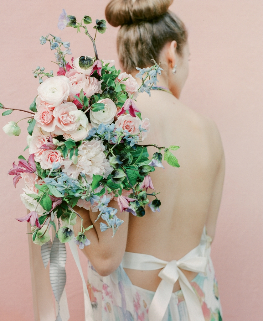 Theia’s “Fae” silk floral halter gown from Fabulous Frocks. Chatelain Collection by David Yurman’s silver, amethyst, and topaz earrings from REEDS Jewelers. Bouquet by Gathering Floral + Event Design.
