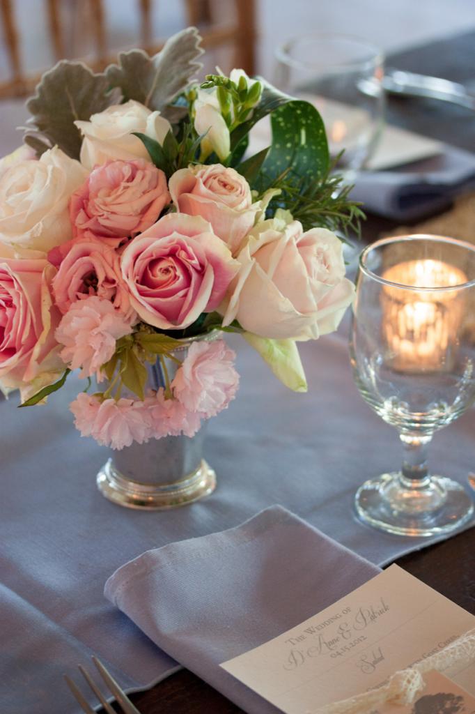 POSY PERFECT: For reception tablescapes, stems placed roses, carnations, and Lamb&#039;s Ear into silver vessels.