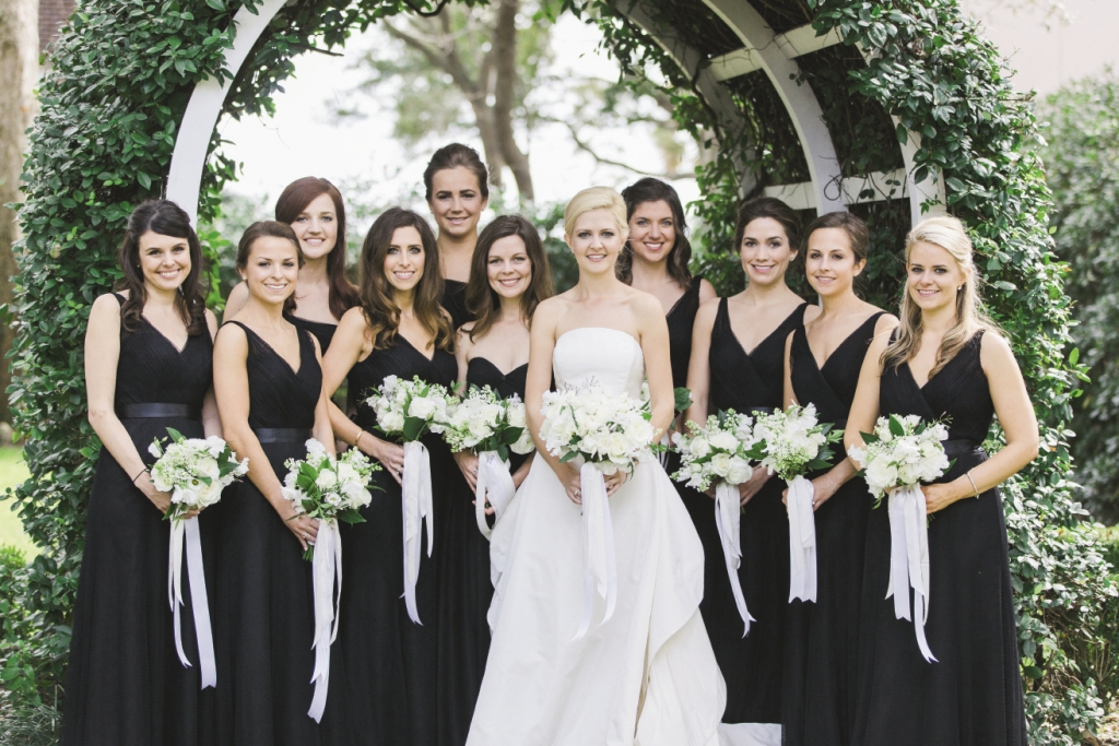 “Our flowers were so simple and white,” says Laura, who loved pairing  cascading satin ribbons with the clean look. Bride&#039;s gown by Oscar de la Renta. Bridesmaids&#039; dresses from Bella Bridesmaids. Florals by Gathering Floral + Event Design. Image by Elisabeth Millay Photography.