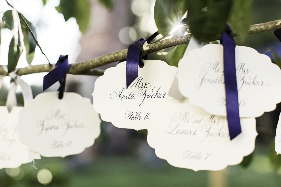 ON A LIMB: Guests found their table assignments on hand-lettered cards tied to tree branches.