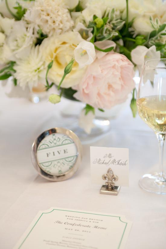 ALL SET!: Table numbers and brunch menus, which were crafted by Quarter Century Creative, matched the couple’s invitation suite, while silver accents added a classic touch.