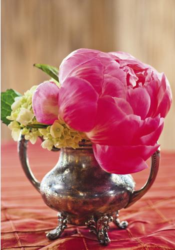 TINY TOUCHES: Small details brightened the evening, like a vibrant peony spilling from this charmingly tarnished antique silver vessel.