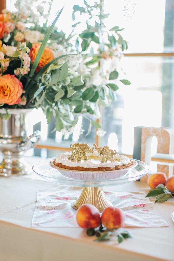 Go Symbolic: In homage to their Thai  honeymoon (and visit to an elephant sanctuary there), pachyderms topped the wedding pie. Peaches gave sweet (and edible) style to tabletops, and home  garden clippings filled out  arrangements of grocery  store blooms.