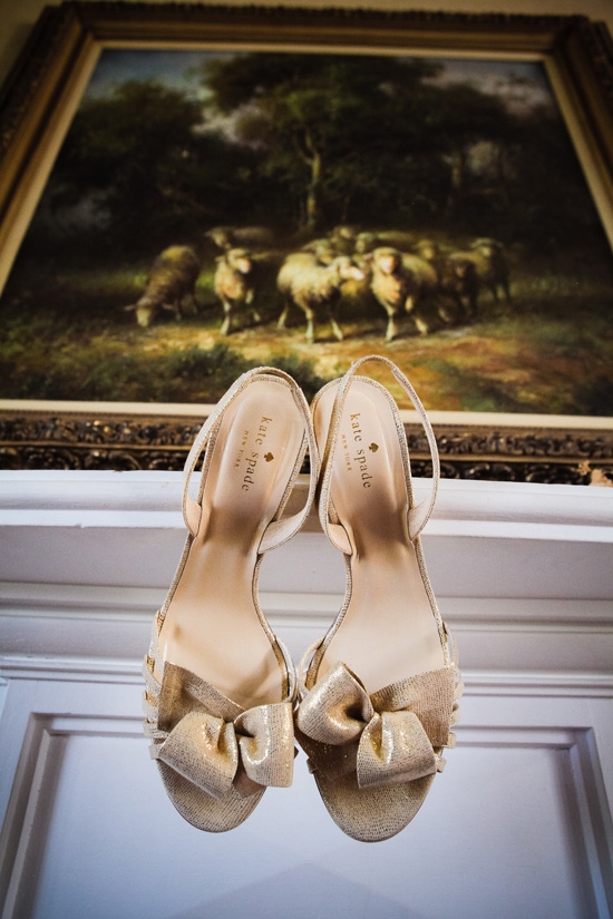 HEART AND SOLES: For the ceremony, Carrie wore gold Kate Spade heels from Copper Penny. Self-admittedly not much of a heels girl, she changed into a pair of London Sole ballet flats for the reception. “I was happy to give my feet a reprieve and boogie the night away in cute flats!” says the bride.
