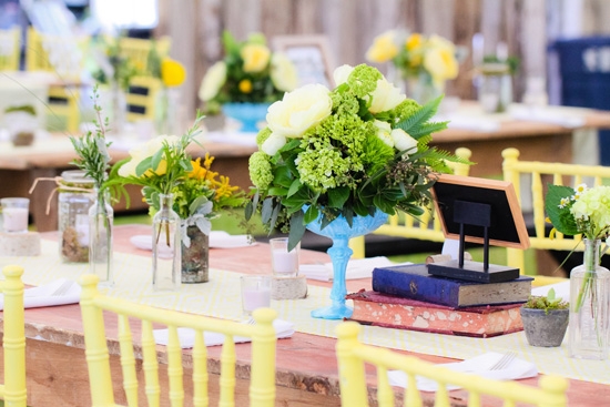 MIXED AND MATCHED: Rather than competing with their bright vessels, the fern fronds, green hydrangea, and yellow peonies of the arrangements complemented the colorful vases.