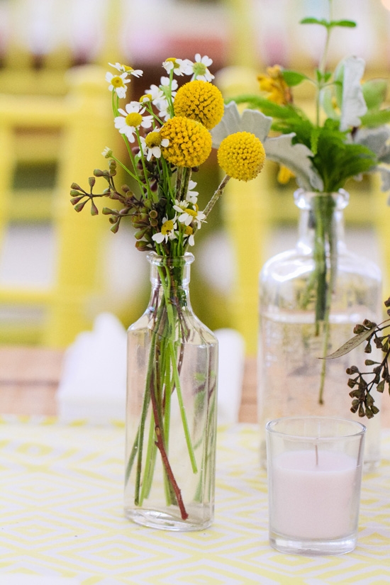 SIMPLE SOLUTIONS: Clear tincture bottles held Billy Balls, daisies, and lamb’s ears.