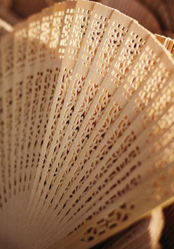 BEAT THE HEAT: Guests fended off warm temps with laser-cut sandalwood folding fans from theknot.com.