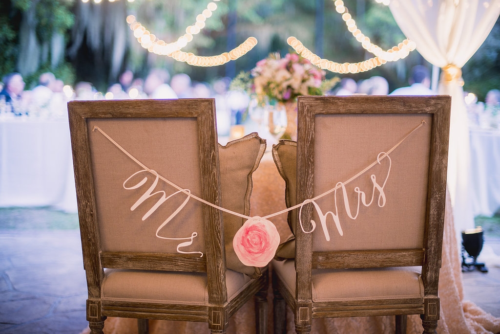 Wedding design by Sweetgrass Social Event + Design. Chairs from EventWorks. Signage by Blue Glass Designs.Image by Timwill Photography.