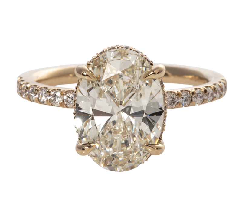 Oval diamond solitaire (3 carats)  micropavé ring in 14K gold from Croghan’s Jewel Box ($45,000)