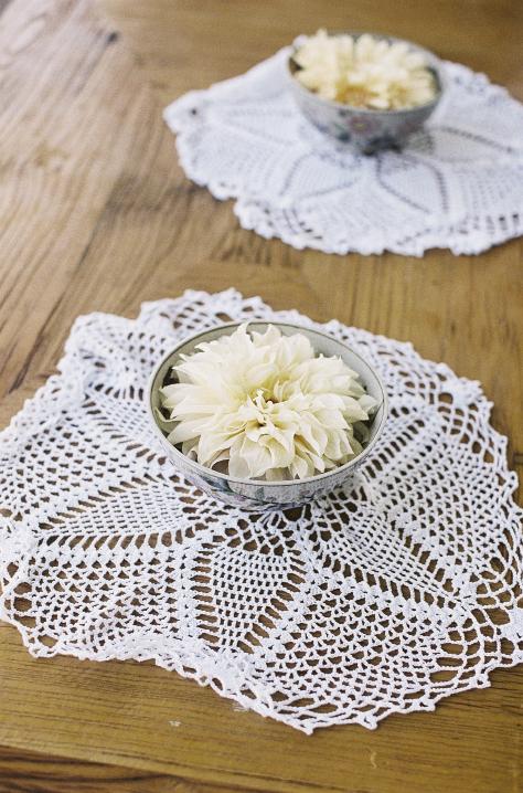 NICE TOUCH: Dinner plate dahlias floated in silver bowls that were placed atop doilies.