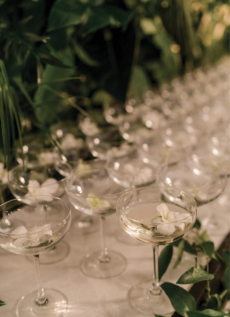 Edible blossoms floated in coupe glasses, adding even more drama to the champagne wall.