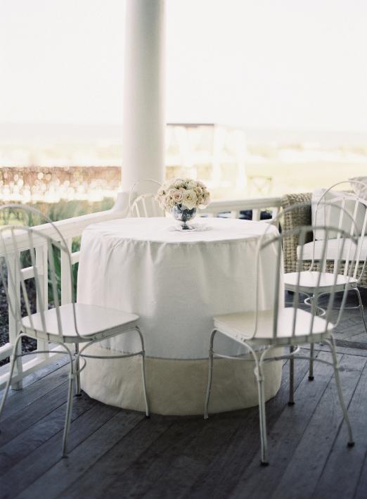 SEASONAL CHOICE: Delicate white chairs and linens were perfect for the warm-weather wedding.