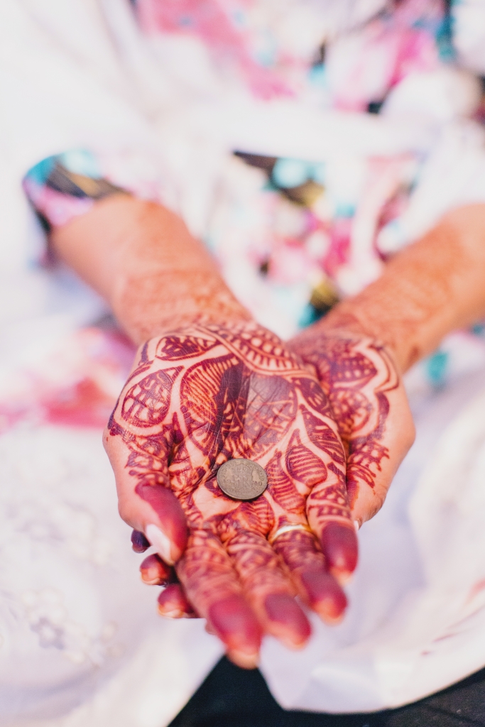 To invite good fortune, Manasa bore intricate henna designs on her palms (painted by a family member of a friend) and tucked a sixpence borrowed from Will’s aunt in her shoe. &lt;i&gt;Photograph by Hyer Images&lt;/i&gt;