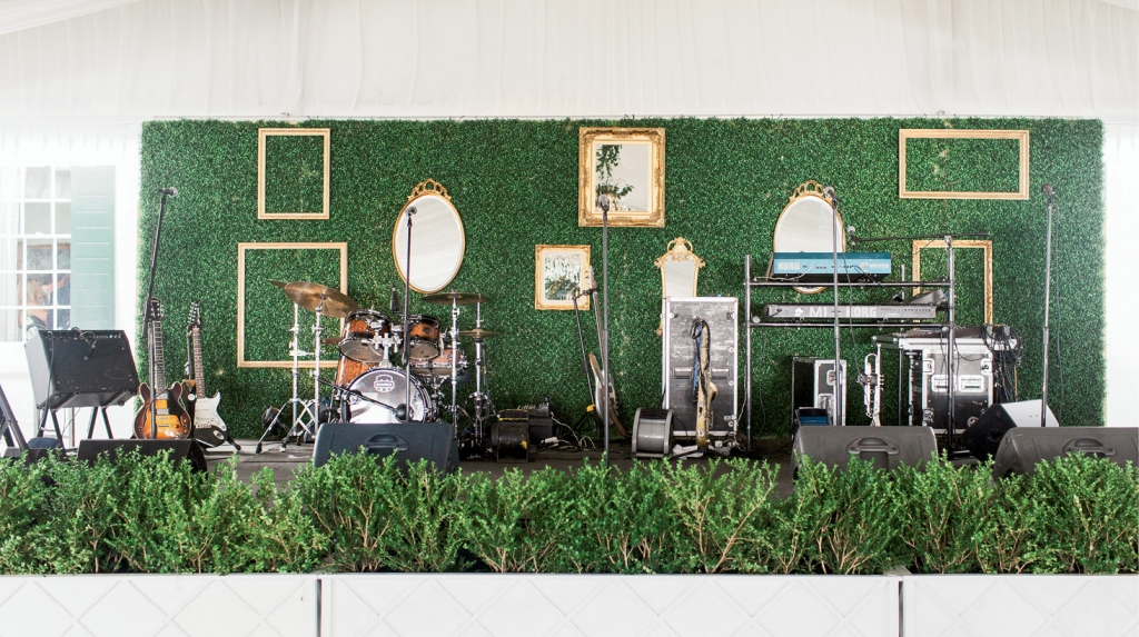 The bandstand backdrop was covered in boxwood greenery and dressed gallery-style with gold mirrors and frames.   &lt;i&gt;Photograph by Gayle Brooker&lt;/i&gt;