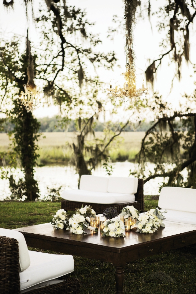 WATER VIEW: Outdoor lounges created intimate gathering areas; here, bridal party bouquets  doubled as floral arrangements when artfully placed atop a coffee table.