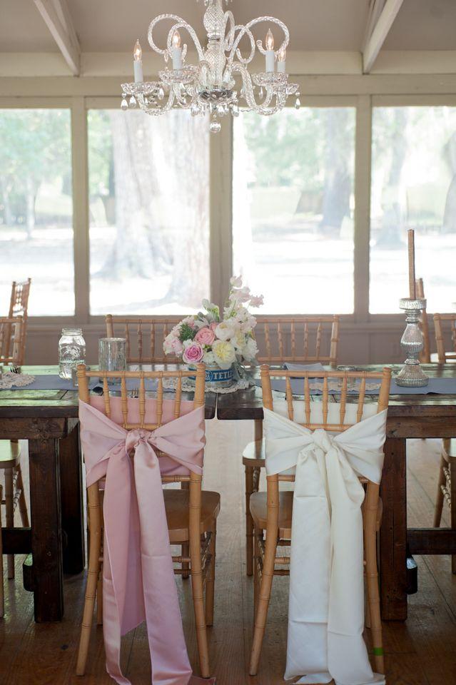 TIE THE KNOT: Coordinating pink and white silk fabric bows draped the bride and groom chairs for a subtle yet elegant addition to the dinner setting.