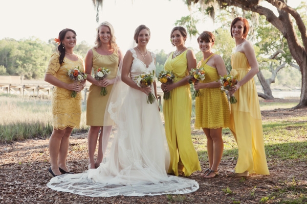 SUNNY SHADES: Bridesmaids wore different styles of yellow dresses, a bold yet cheery complement to Lindsey’s vintage-styled gown