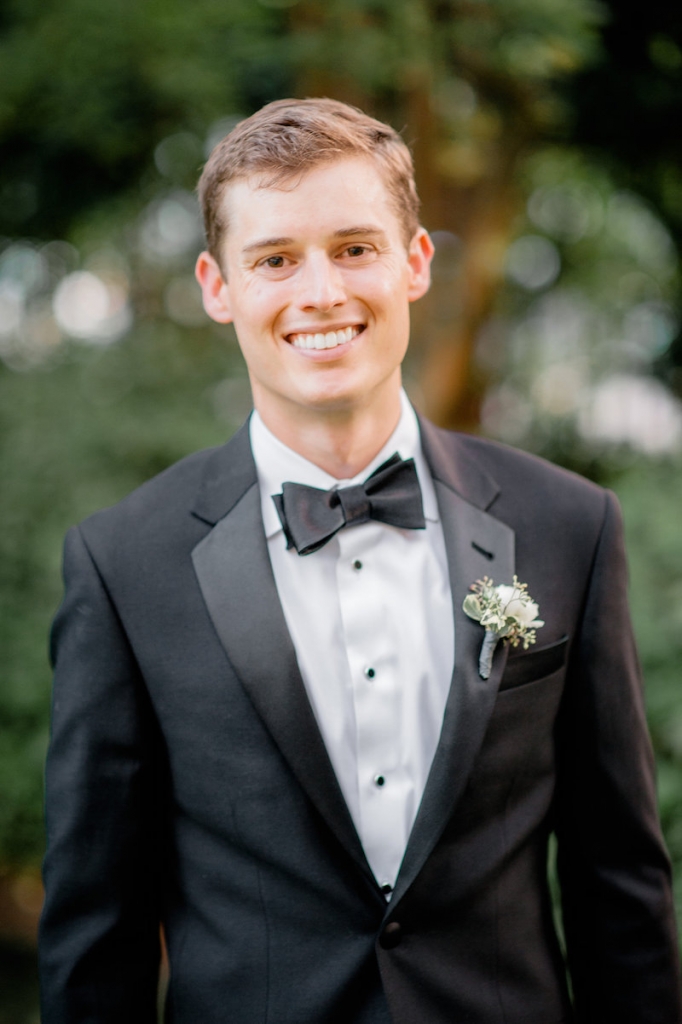 Groom&#039;s attire from The Black Tux. Boutonnière by Out of the Garden. Photograph by Brandon Lata.