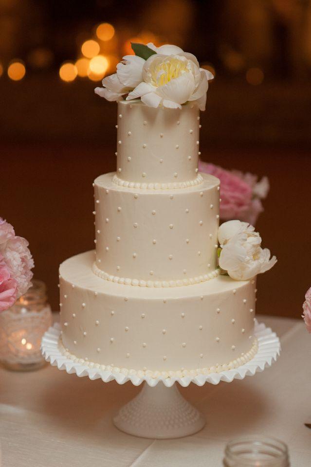 SWEET &amp; SIMPLY: The Cake Stand’s triple-tiered cake was decorated with Swiss dots and garnished with two pale peonies.