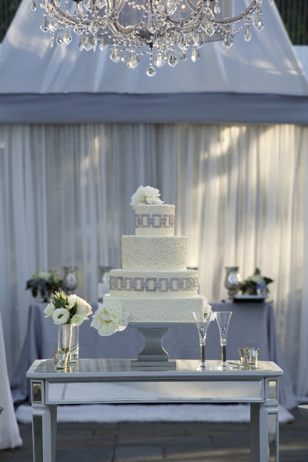 LASTING IMPRESSION: “From the stunning mirrored cake table and my parents’ Art Deco champagne flutes to the dramatic mirrors and gorgeous chandeliers, the design was beautiful and timeless,” says Chloe of the reception.