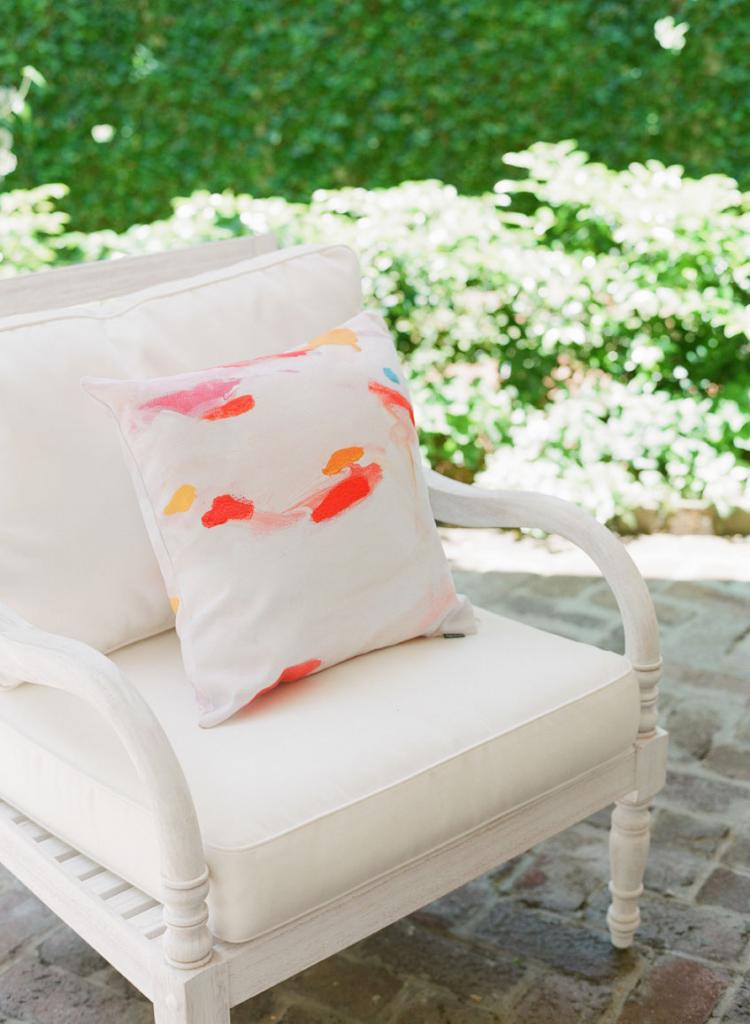 Watercolored pillows dressed lounge chairs.