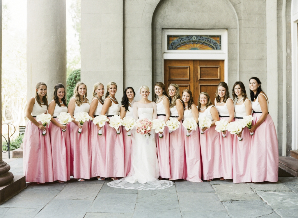 “There is nothing more feminine than a bridesmaid,” says the bride, who chose LulaKate little white dresses with custom overskirts.  Bride&#039;s gown by Amsale (available locally at White on Daniel Island). Bridesmaids&#039; dresses by LulaKate. Florals by Tara Guerard Soiree. Photograph by Corbin Gurkin.