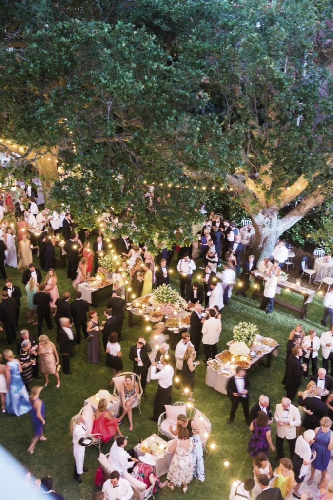 Low-reaching live oak tree limbs meant Tara’s team couldn’t tent the entire garden but luckily the weather held, so the only thing between guests and the wide open sky were the twinkling lights that mingled with branches. Photograph by Corbin Gurkin.