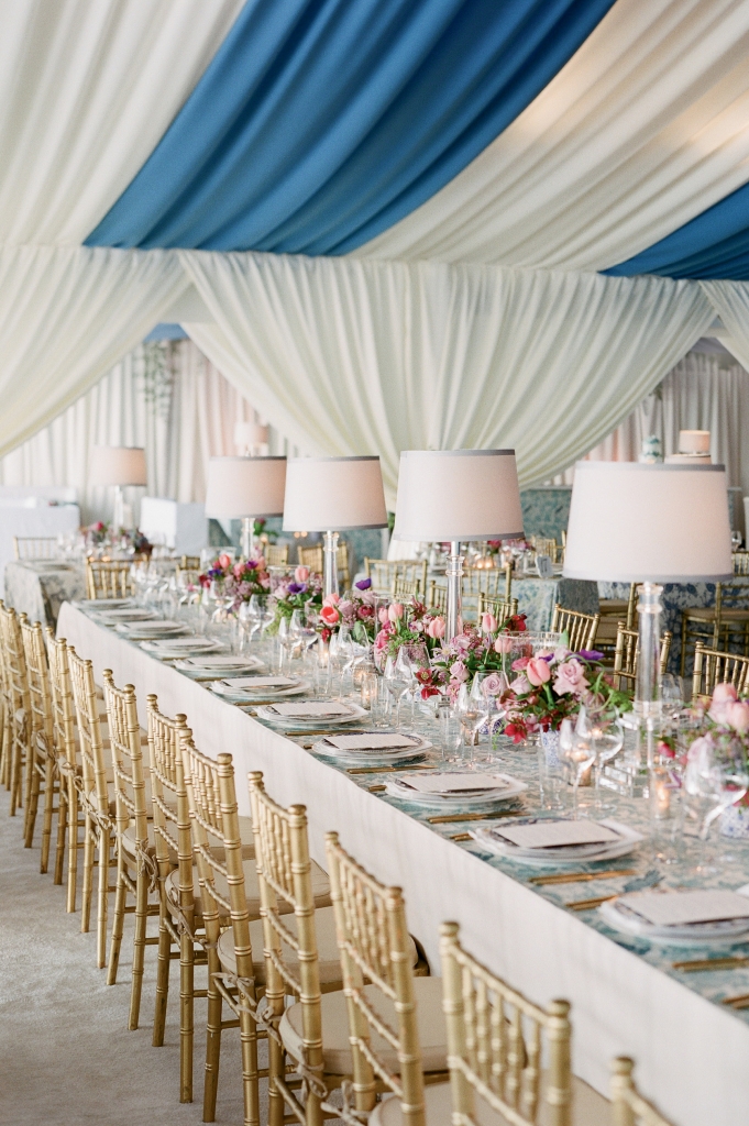 When the couple selected French Blue as their central color, Tara wondered, “Everyone loves a blue-and white-wedding, but how can we make it stand out?” Mix-and-match fabrics did the trick. Tables were dressed in a mélange of custom-made linens in blue-hued florals, patterns that offset the bold ceiling draping. The final touch? Sheer white curtains around the perimeters.  (Photo by Corbin Gurkin)