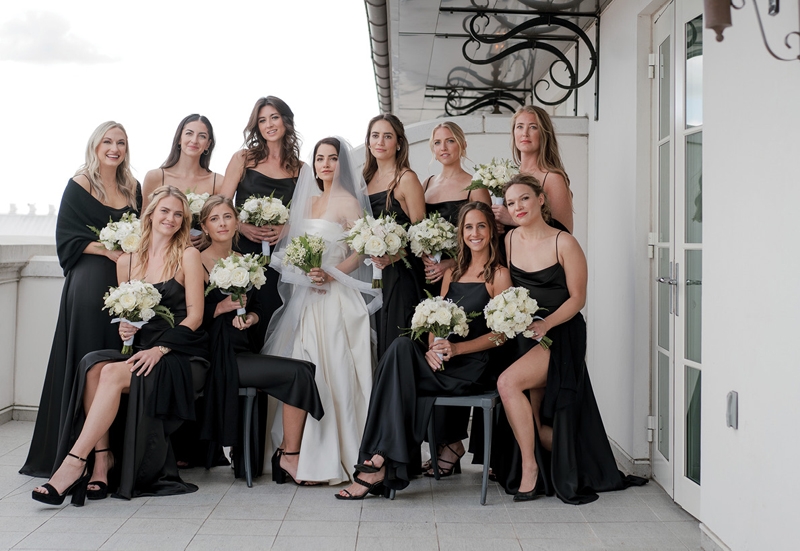 White rose and peony bouquets popped against black silk bridesmaid dresses.