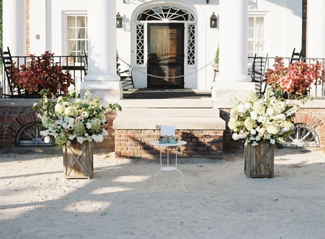 SPACE MAKERS: To create the idea of an altar space, two planters brimming with fresh blooms stood at the end of the aisle.
