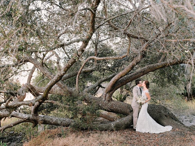 Bridal gown by Allure Bridals, available in Charleston through Bridals by Jodi. Groom’s suit from Express. Groom’s vest from J.Crew. Bouquet by Branch Design Studio. Image by Amy Arrington Photography at Old Wide Awake Plantation.