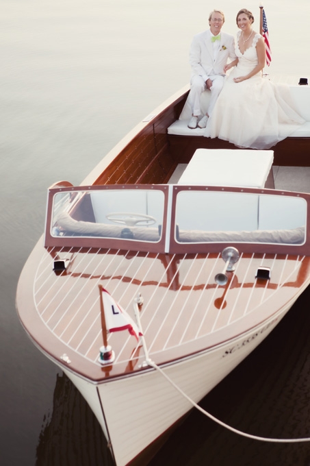 AMERICAN ROMANCE: For a couple with a shared love of boats, their 1959 wooden-hulled Lyman Boat with its classic look and patriotic spirit was the perfect choice for a getaway vehicle (and post-ceremony pictures).