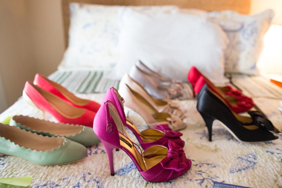 We spread the shoe options out on the guest room bed in our staging cottage. Peep-toe pumps and pretty flats, bright colors, and satin, suede, and lamb leather were the name of the game. Image by Juliet Elizabeth Photography