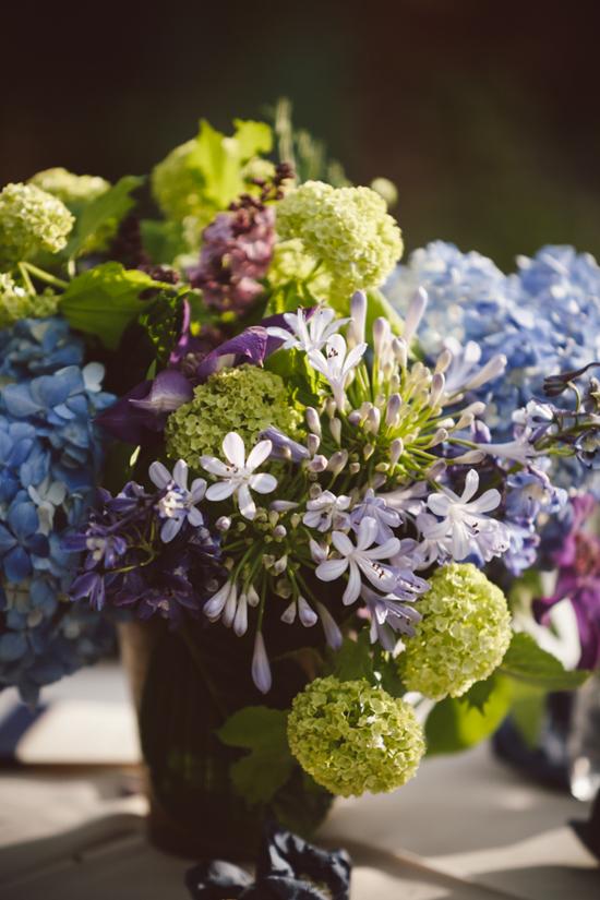 SMALL &amp; MIGHTY: Petite purple nerine lilies dotted the centerpieces. While pinks and blues showed up in the florals, other colors and a variety of texture helped to break up the blooms and give the arrangements depth.