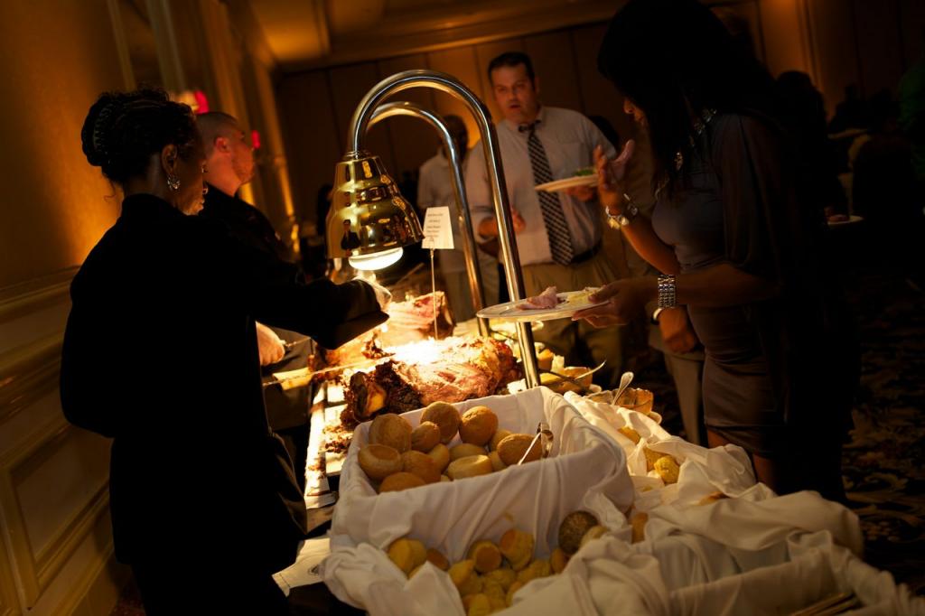 DISHING IT OUT: The Charleston Place hotel catered the reception feast, which included various stations like this carving table. The bride’s one regret of the night? “We would have eaten more of our amazing food that was being served during the reception!” says Richelle.