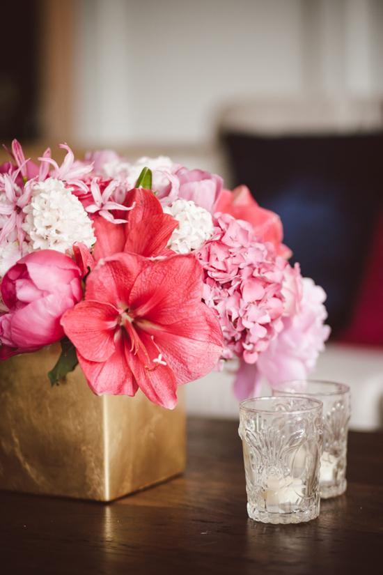 TROPICAL INFUSION: Gathering Floral + Event Design tucked surprise blooms—like this hot pink hibiscus—into the centerpieces.