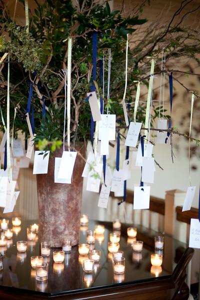 HANGING OUT: Spencer Special Events used palette-matching ribbons to hang escort cards from arrangement branches.