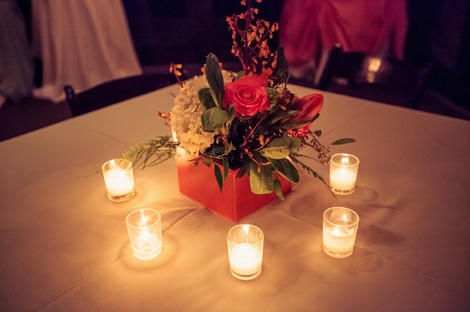 GATHER &#039;ROUND: Wooden boxes painted in one of the reception&#039;s lead hues held bright florals and were surrounded by a circle of sweet and simple tealight candles.