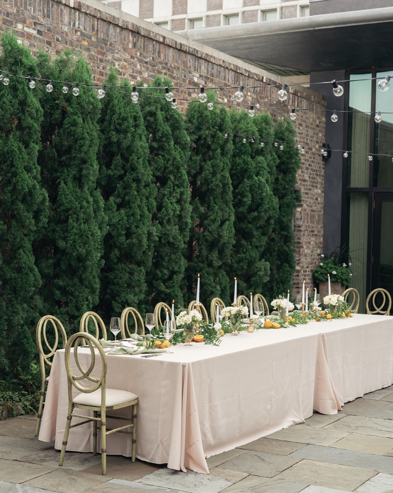 Wisps of fresh greenery and bright citrus against elegant pastel linens suited the Dewberry’s walled garden.