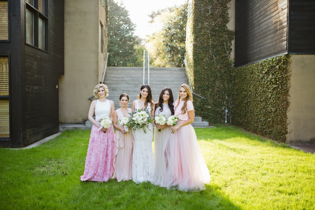(From left to right) Custom-made bridesmaid ensemble. Bridesmaid’s gown from BCBG. Bride’s gown by Inbal Dror. Bridesmaid’s gown from Needle &amp; Thread. Custom-made bridesmaid ensemble. Florals by Out of the Garden. Hair by Swish. Makeup by Ooh! Beautiful. Image by Clay Austin Photography.