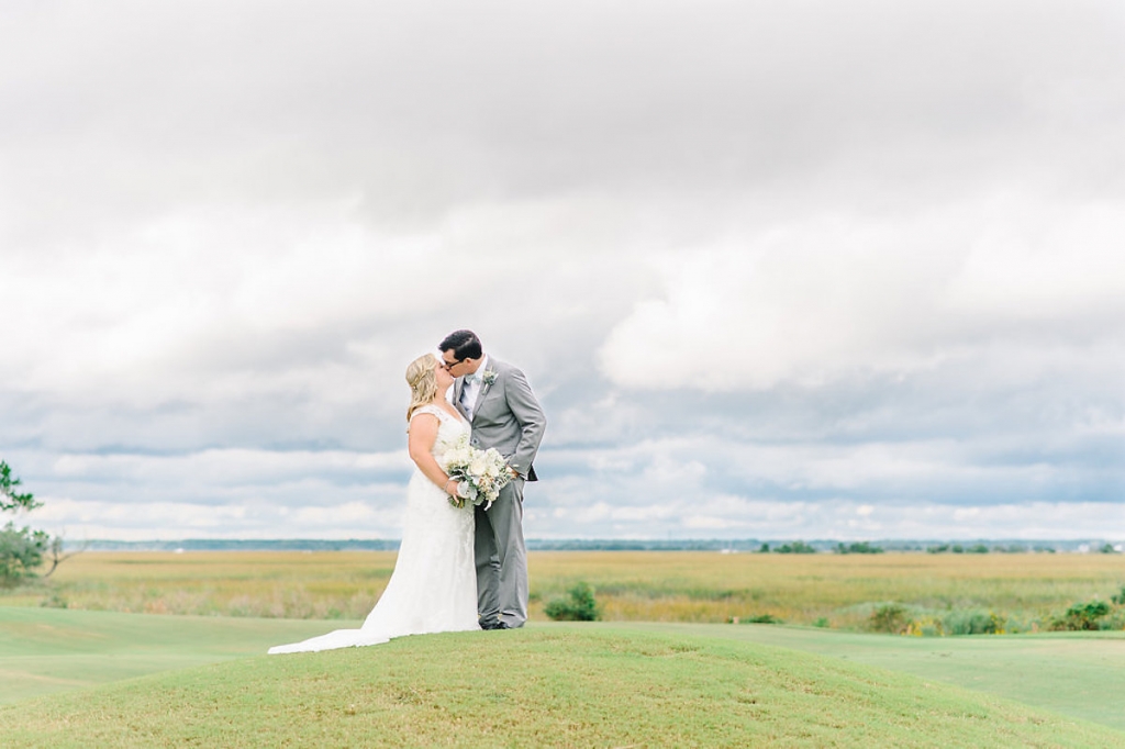 Bride&#039;s gown by Maggie Sottero, available in Charleston through Bridals by Jodi. Groom&#039;s tux from The Black Tux. Image by Aaron and Jillian Photography at Wild Dunes Resort.
