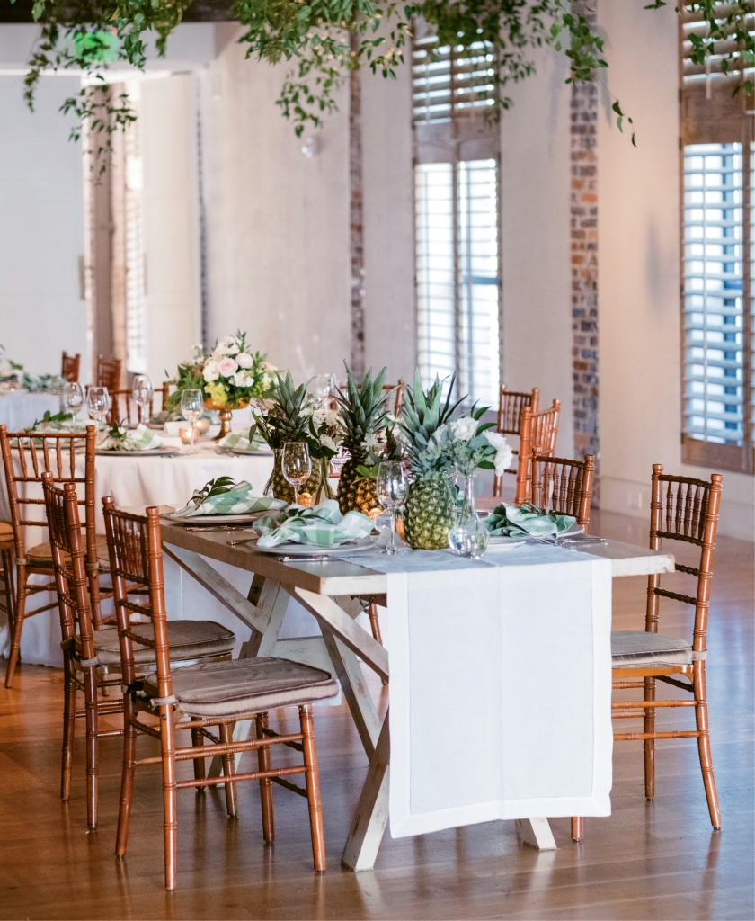 Nice Thinking! - In addition to the florals decorating tabletops, greenery and twinkling lights were woven into the eaves above. Overhead installations like these soften a setting without the expense of custom lighting or draped fabric.