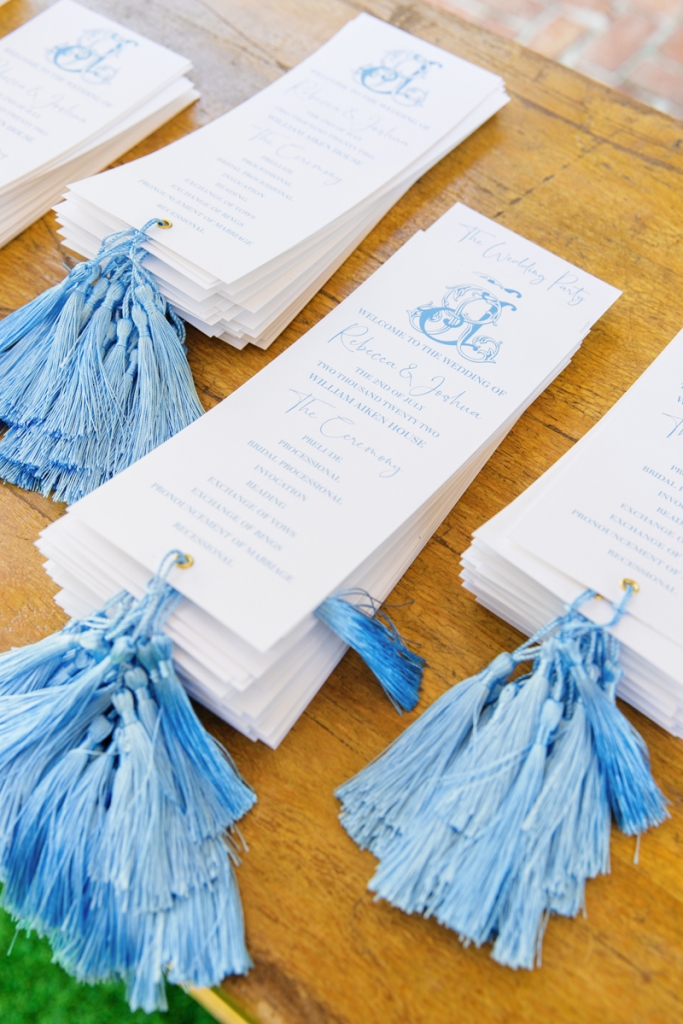 Wedgwood blue calligraphy and tassels on the programs.