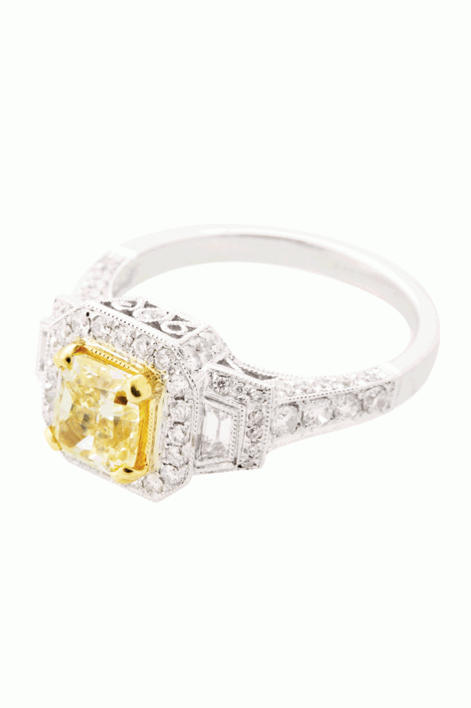 HEART OF GOLD: 18K white gold ring with a cushion-cut Forevermark yellow diamond center in a yellow gold bezel setting with a halo and band inset with pavé diamonds Paulo Geiss Jewelers, price upon request