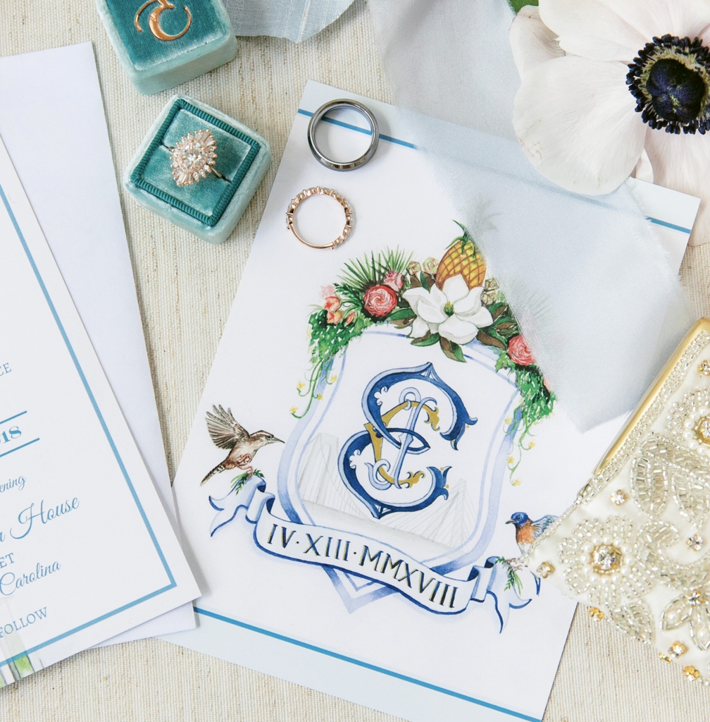 When Caitlin Smith wed Joseph Eyerman at The William Aiken House, the Etsy illustrator painted this crest with his-and-her, New York-meets-South Carolina elements. Crest by the Fox and Bloom. Image by Dana Cubbage Weddings