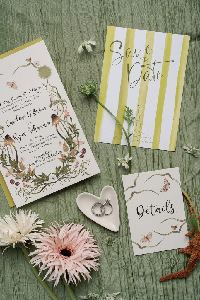 The magical, mossy forest theme was reflected throughout, including in the invitations, designed by the bride and shown here with feather-like spider Gerbera daisies.