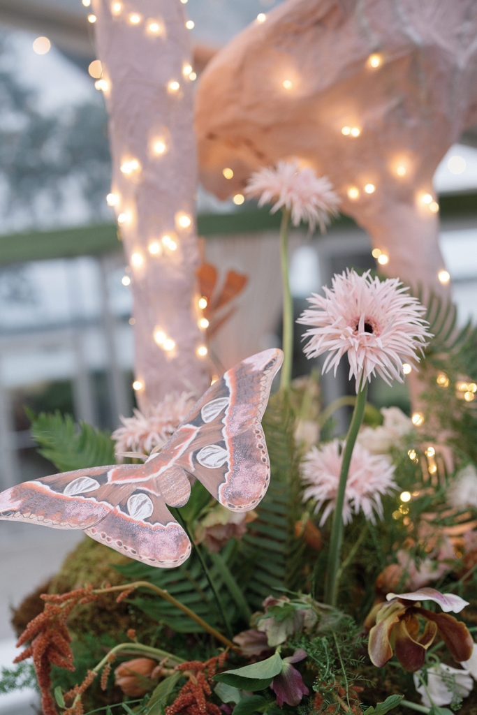 Candles and twinkle lights evoked fireflies and fairies, while other forest creatures like butterflies offered little surprises within the arrangements.